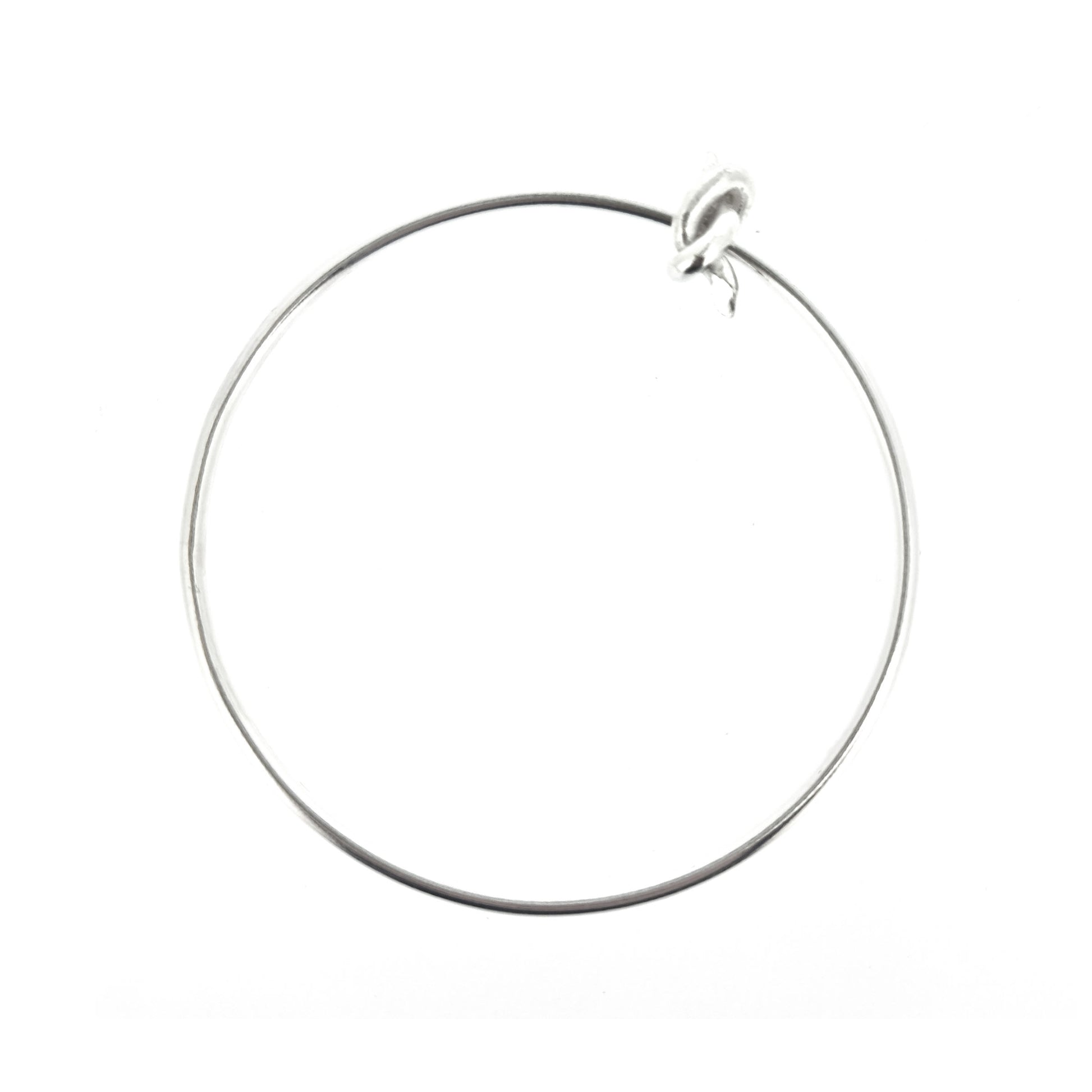 Silver round bangle with spinning knot charm.