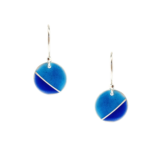 Silver round drop earrings with blue enamels. A silver line runs at an angle across the circle with light turquoise blue in the top part and dark royal blue in the bottom part.