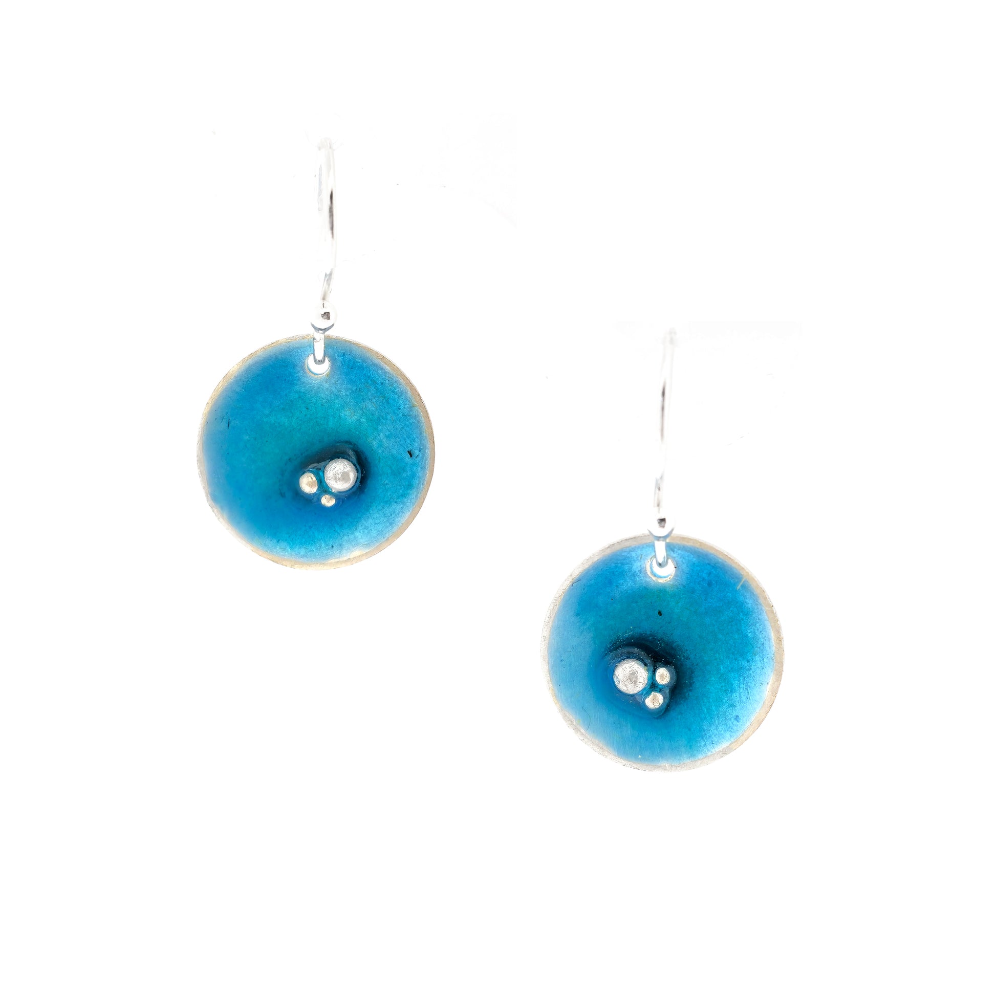 Round silver drop earrings. Each earring has 3 silver balls off-centre and a turquoise blue enamel. Suspended from silver ear hooks.