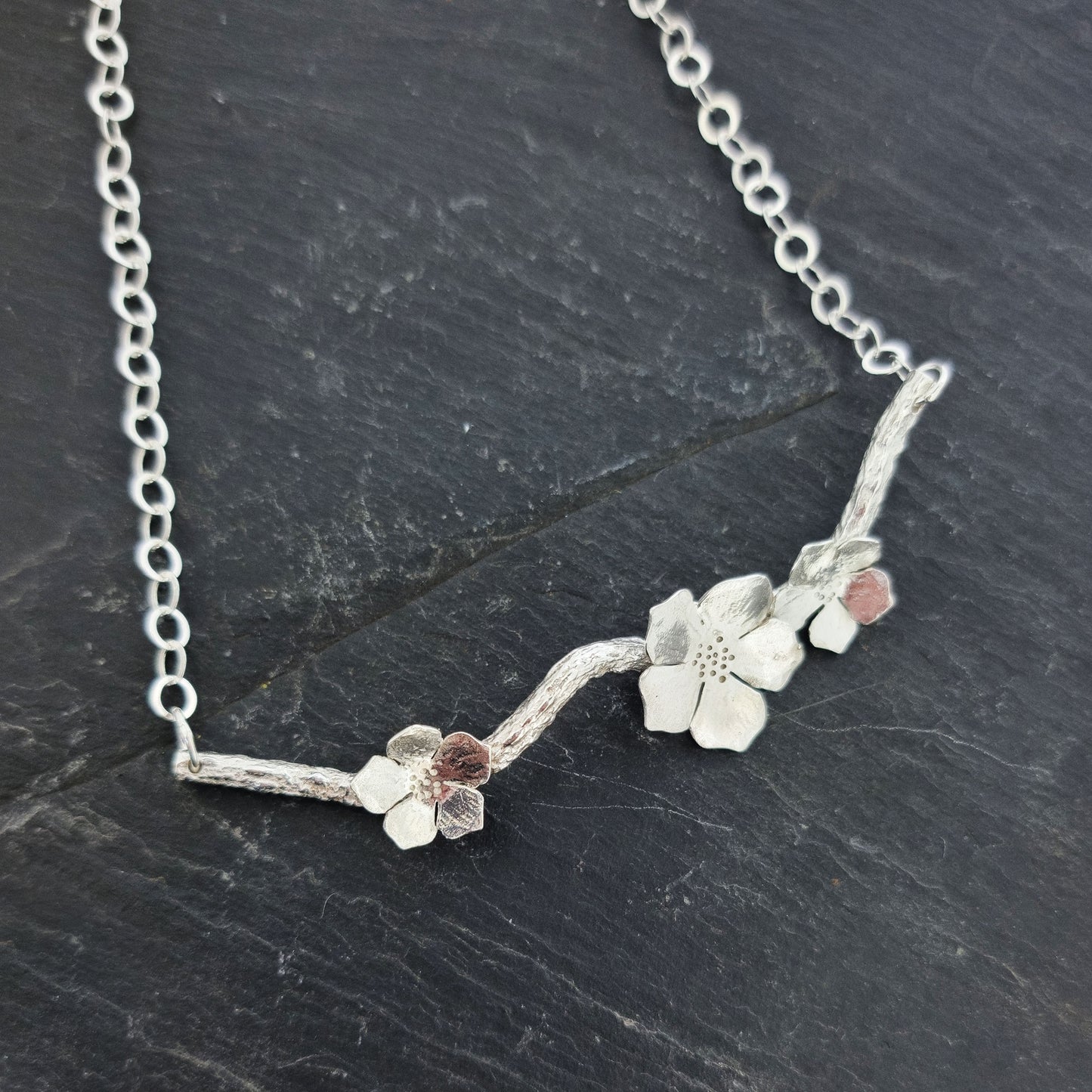 Silver branch necklace with three blossom flowers and open large link chain.