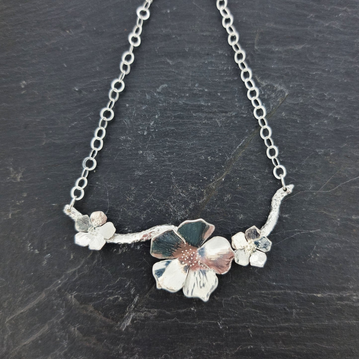 Silver branch necklace with three blossom flowers and open large link chain.