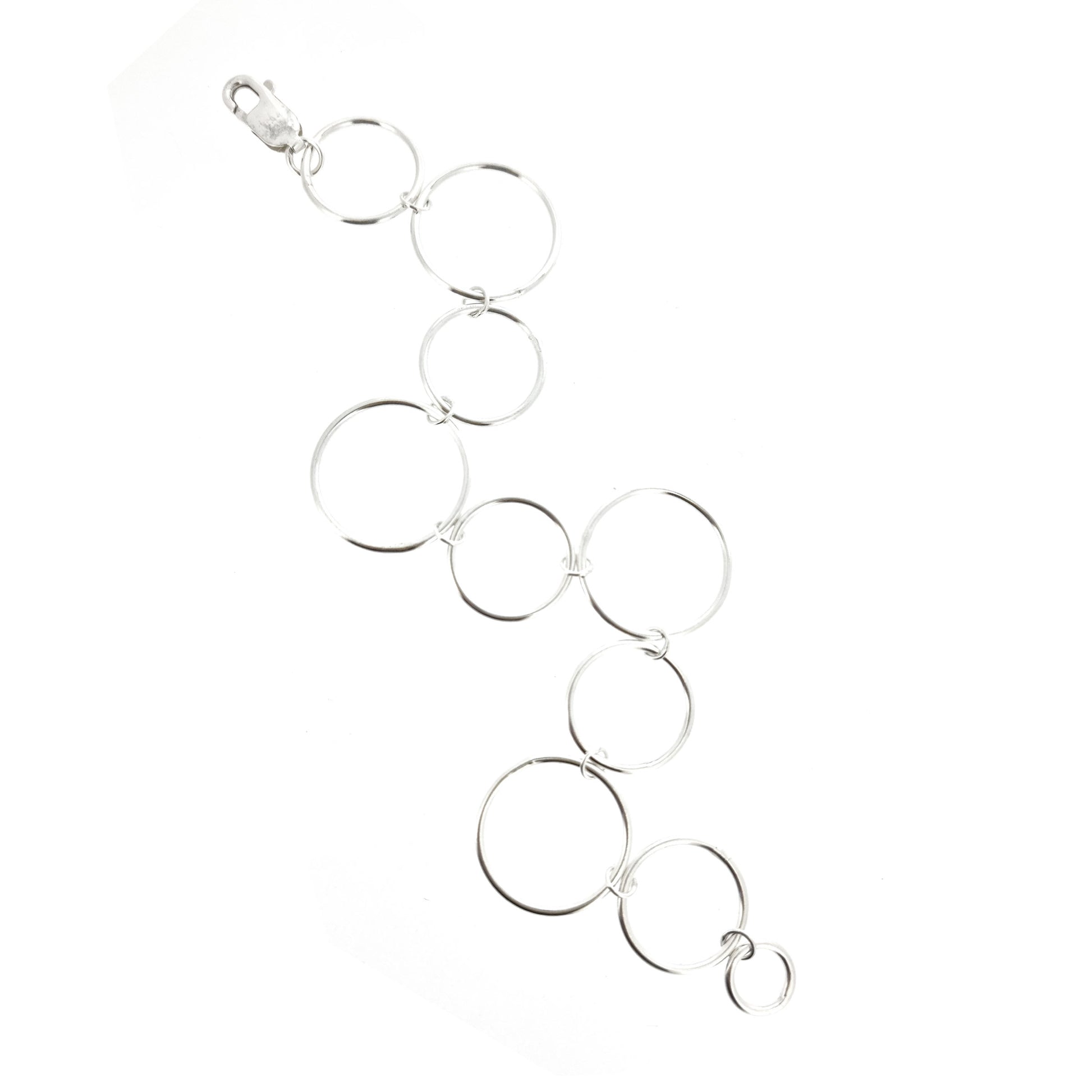 Silver chain link bracelet with circle links of different sizes.