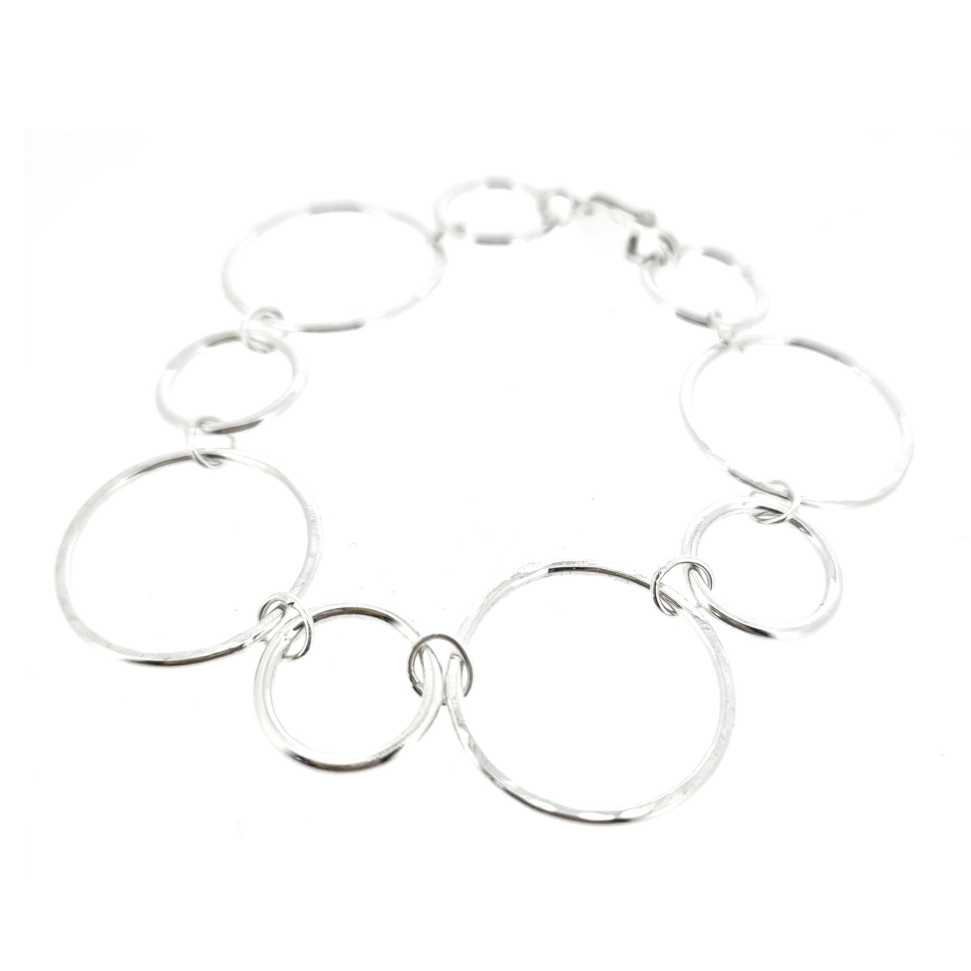 Silver chain link bracelet with 2 sizes of circles, one size has a hammered finish