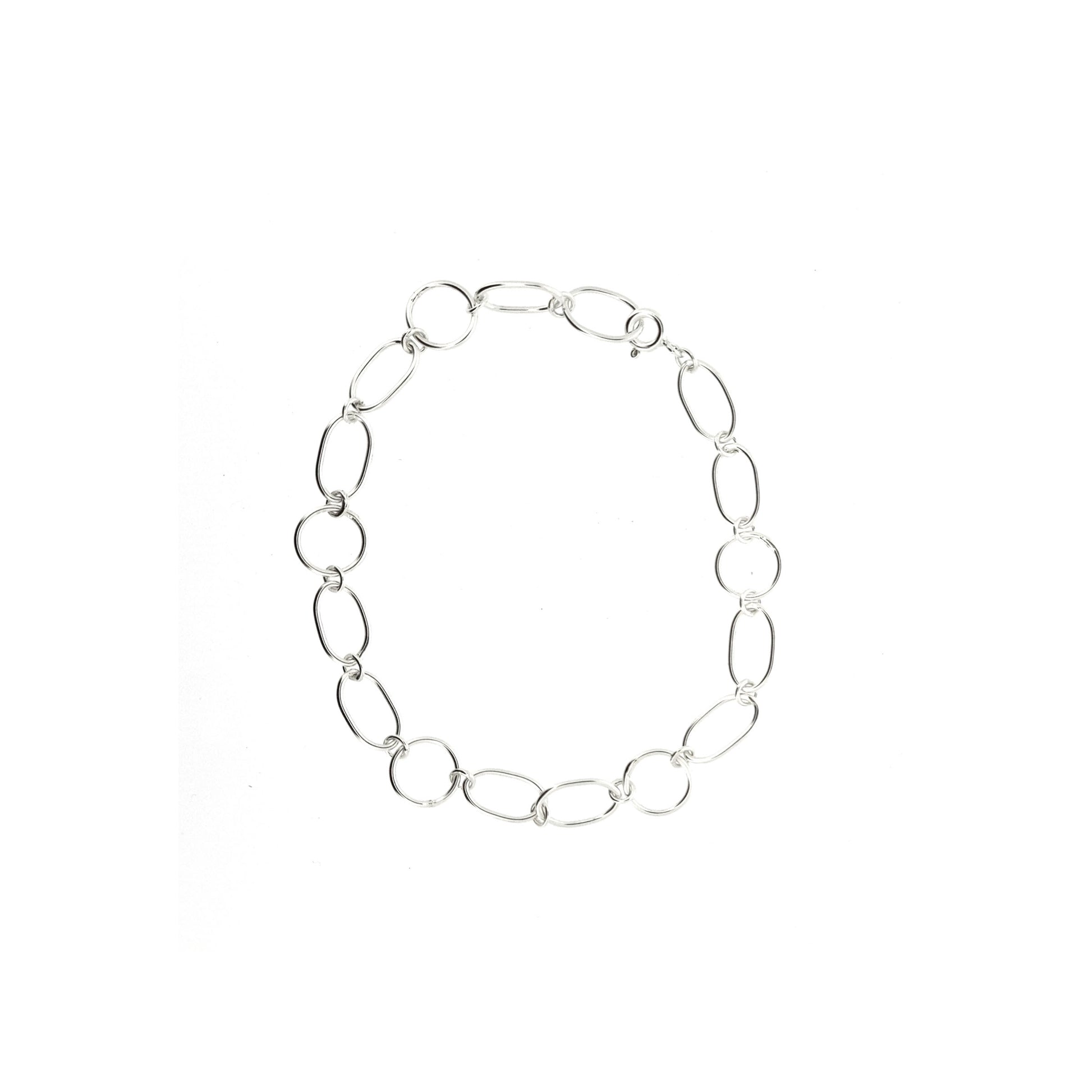 Silver chain link bracelet made of oval and circle links.