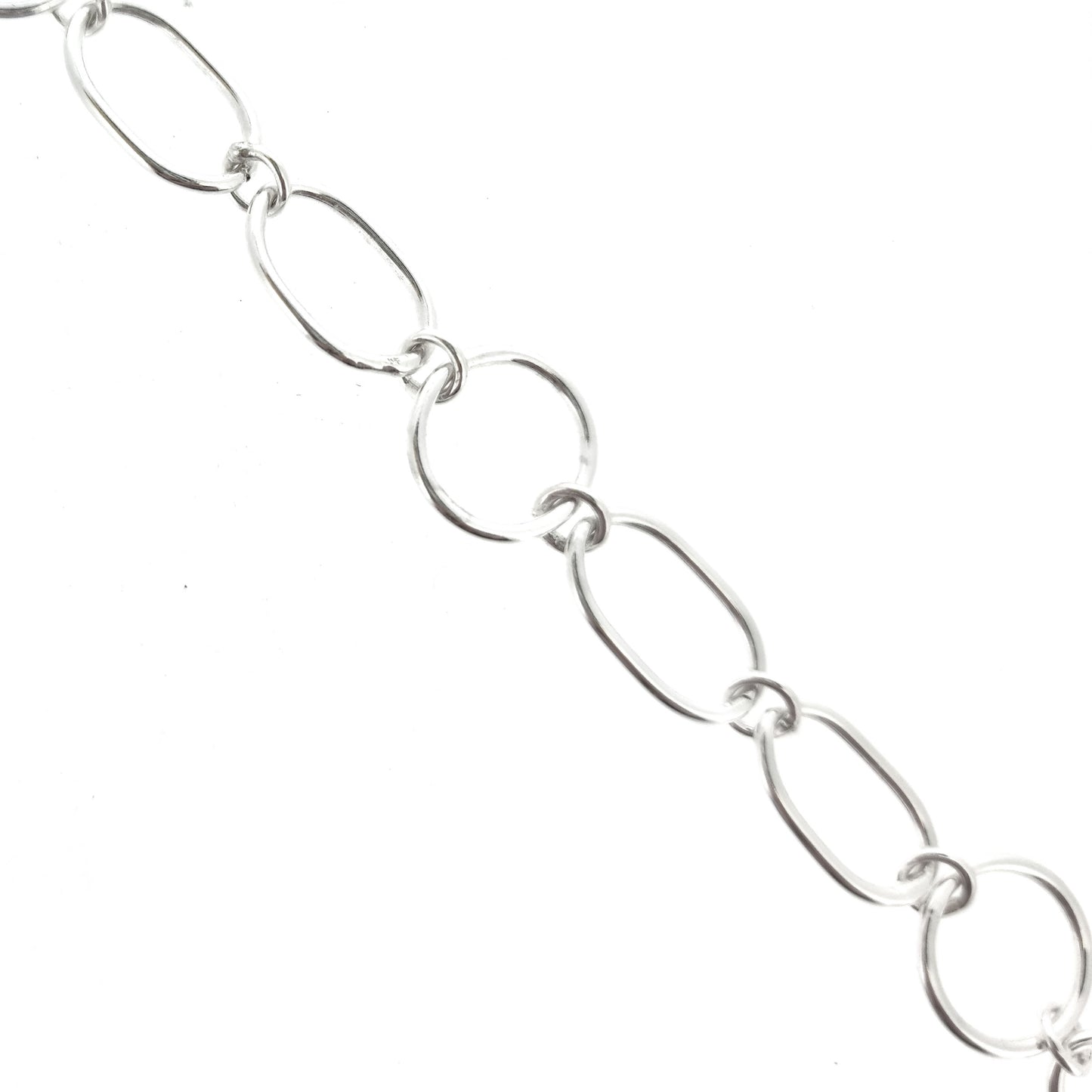 Silver chain link bracelet made of oval and circle links.