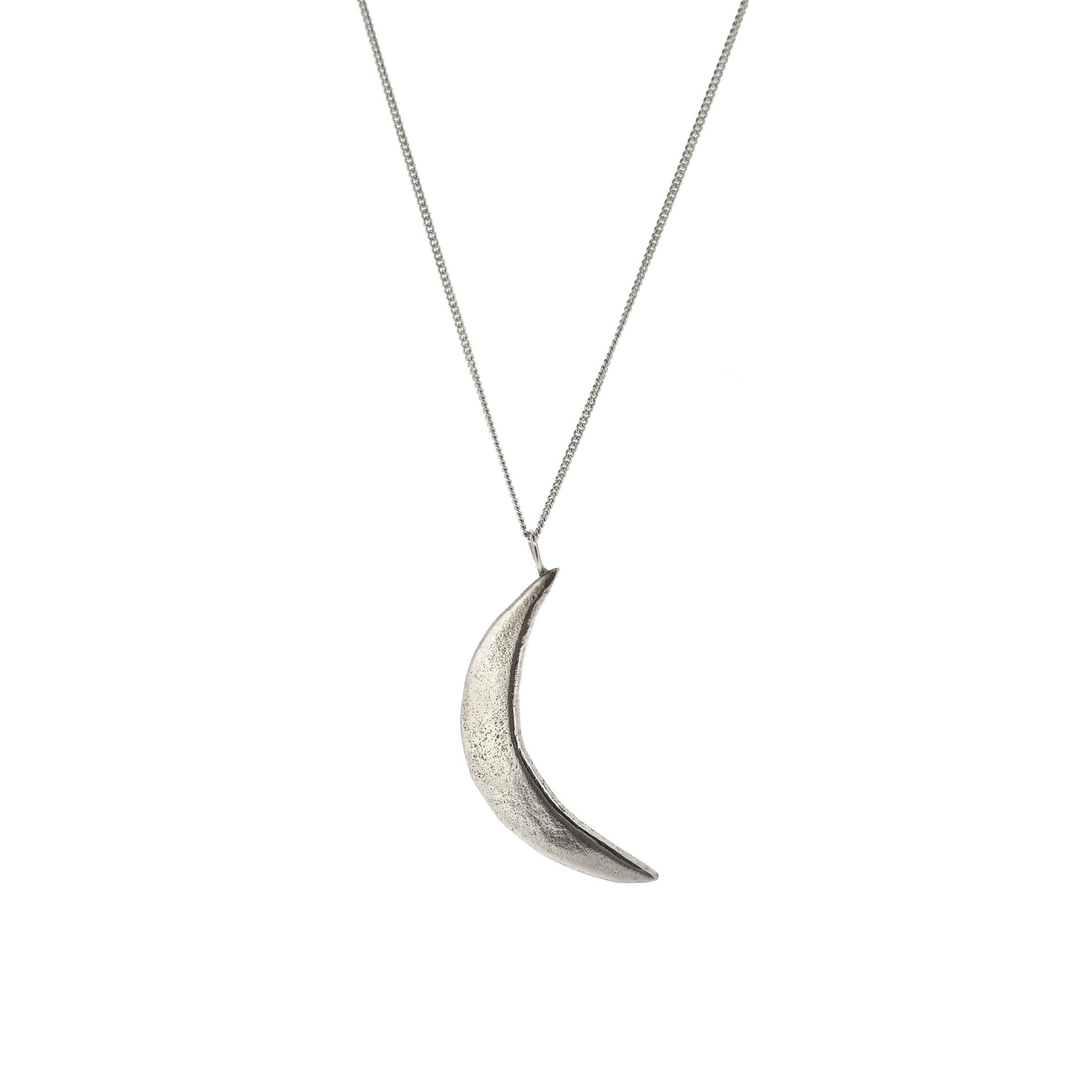 A rustic silver crescent moon pendant on a silver chain.