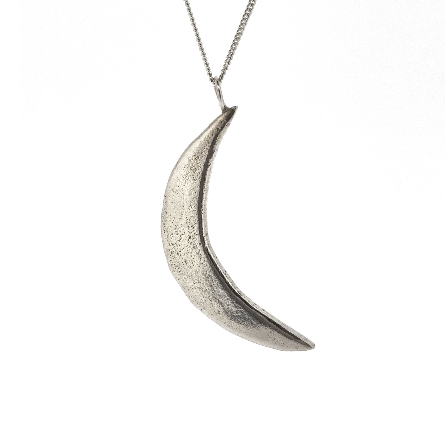 A rustic silver crescent moon pendant on a silver chain.