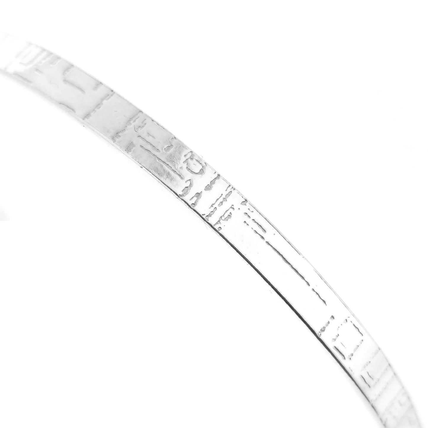A close up of a flat sterling silver bangle with a square and line pattern. Mijoux Jewellery.