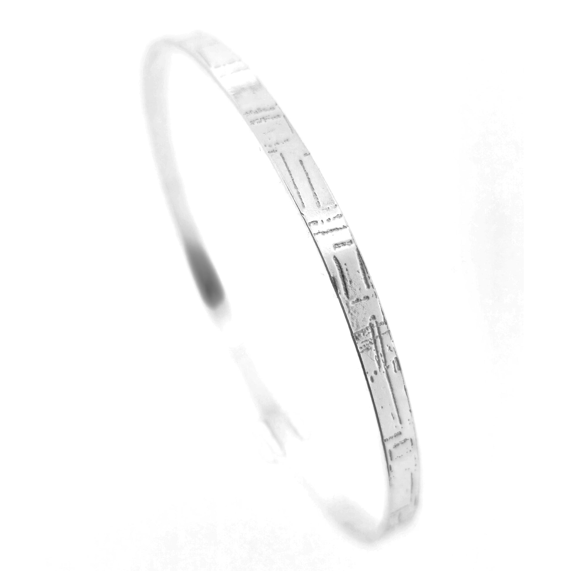 A flat sterling silver bangle with a square and line pattern. Mijoux Jewellery.