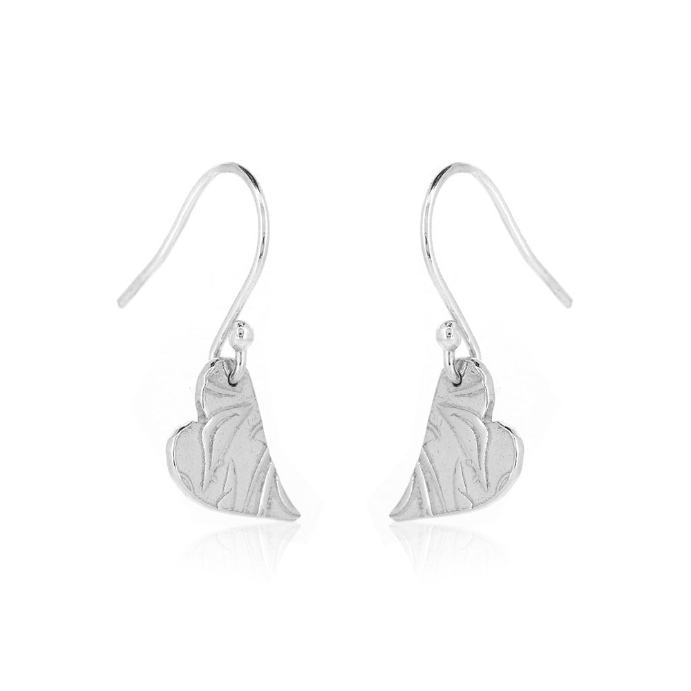 Silver heart drop earrings featuring an asymmetrical heart with a leaf and vine pattern suspended from silver ear hooks.