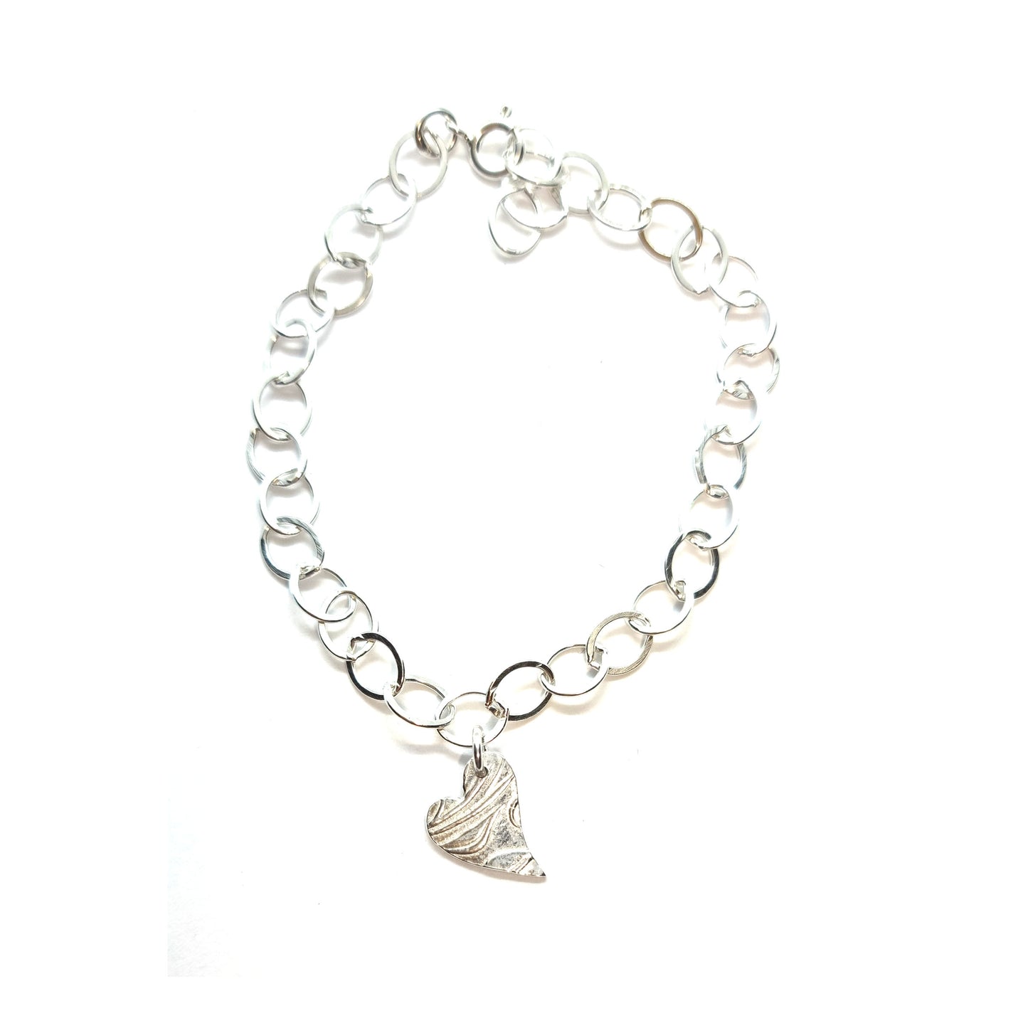 Silver large link chain bracelet with asymmetrical patterned heart charm.