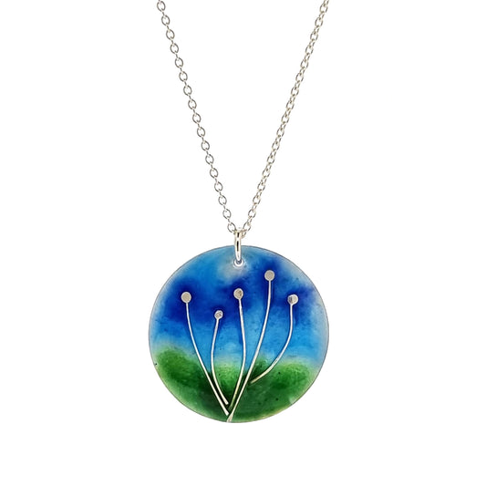 Round silver pendant with silver flowers and blue & green enamels. On silver chain.