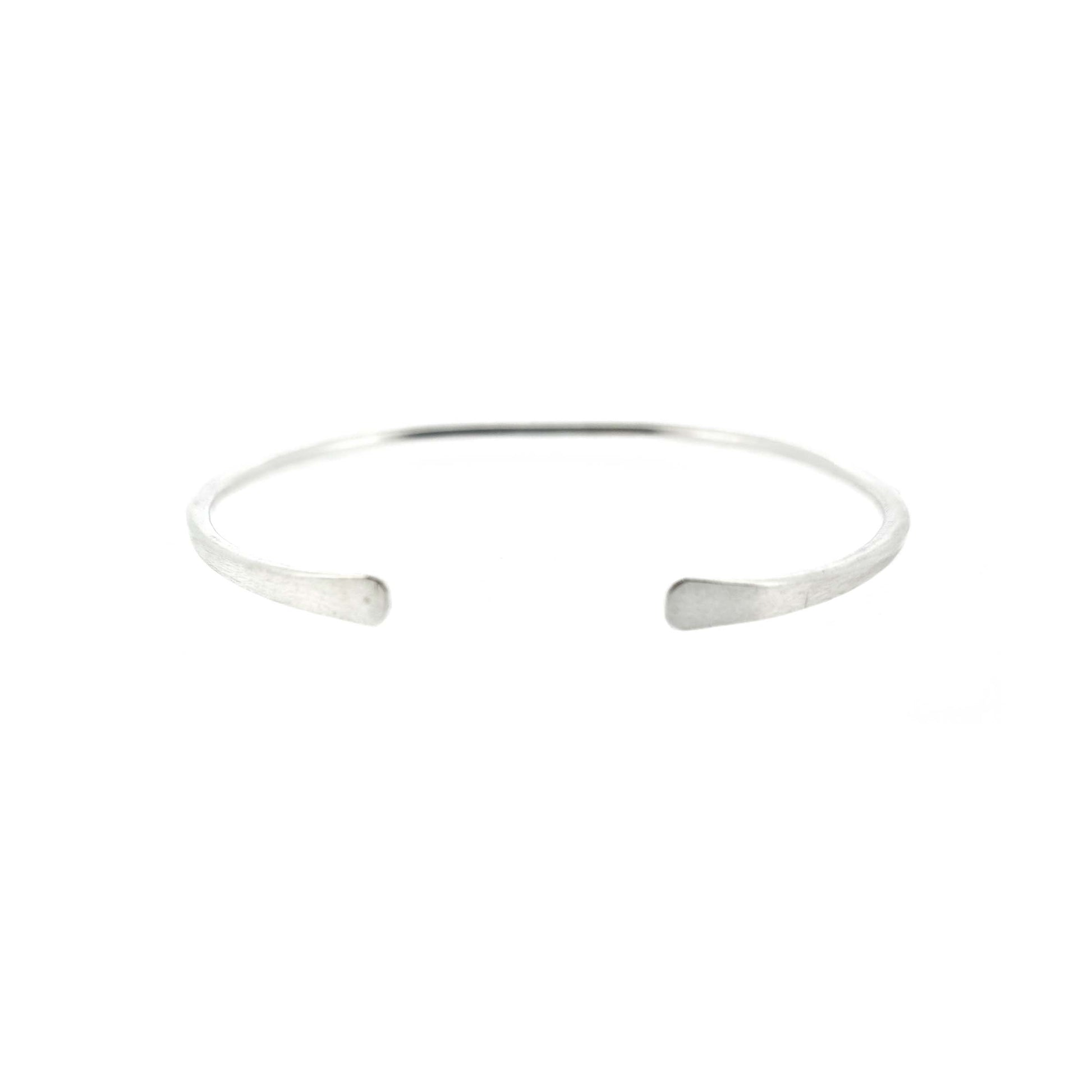 A silver open torque bangle with flattened ends.