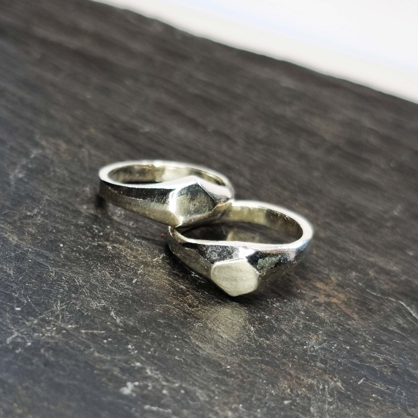 Two silver geometric signet rings with flat head.
