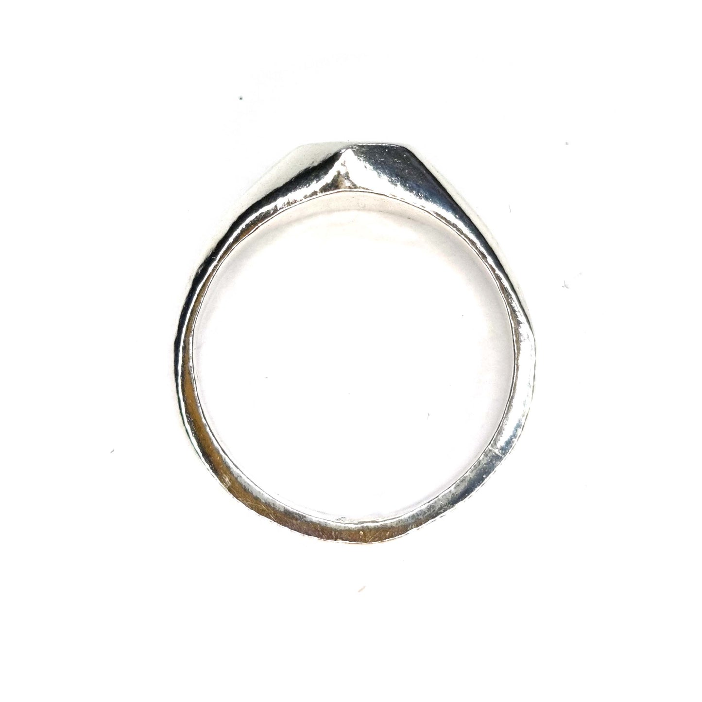 A silver geometric signet ring with flat head. - side view