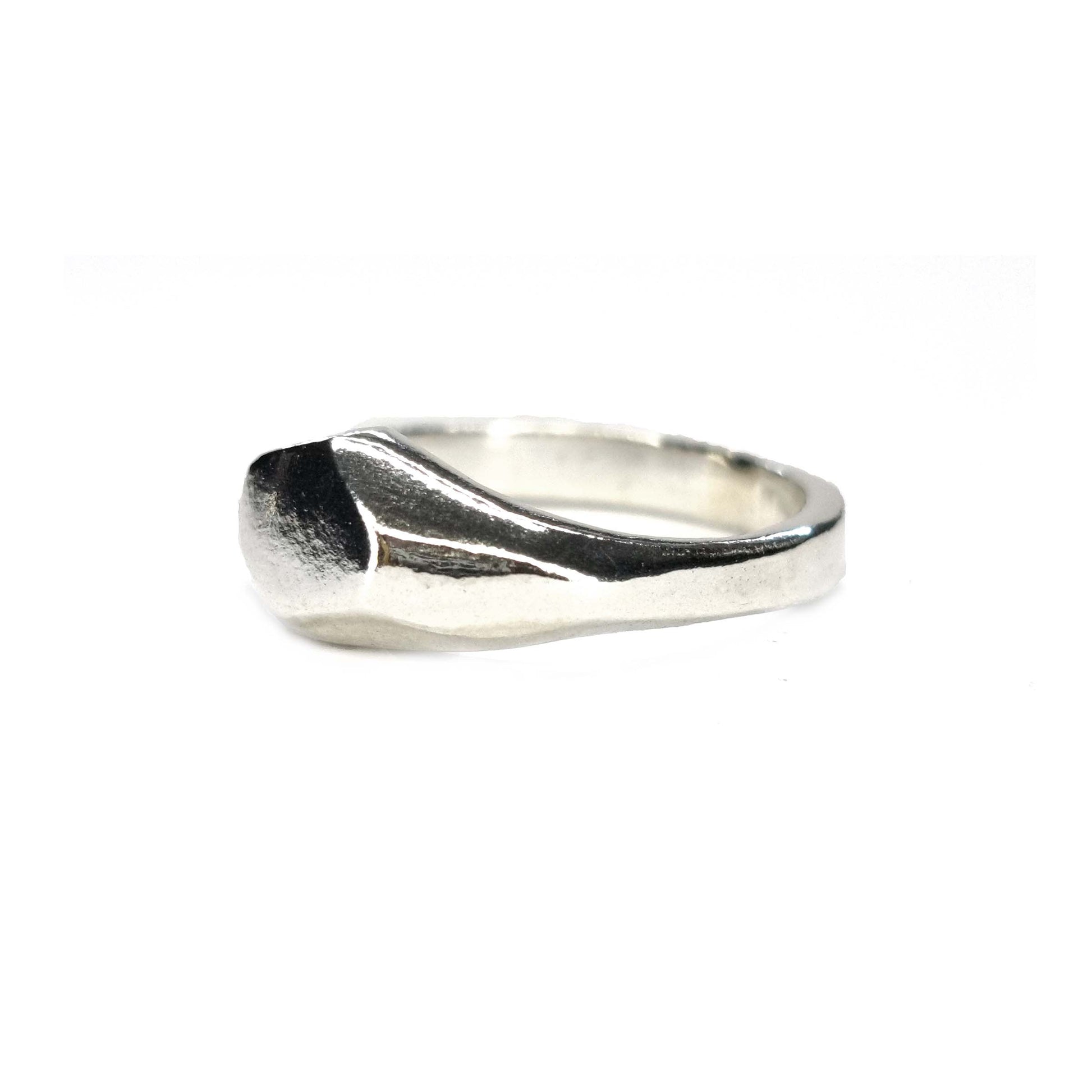 A silver geometric signet ring with flat head.