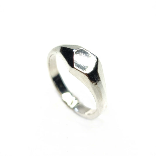 A silver geometric signet ring with flat head.