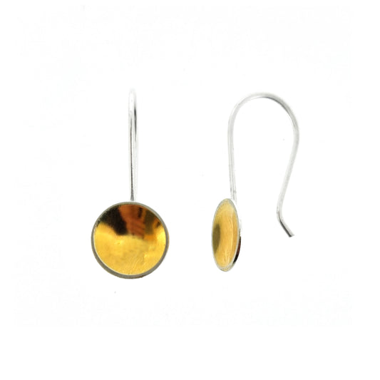 Silver drop earrings with a domed round section with a gold center suspended from a silver ear wire.