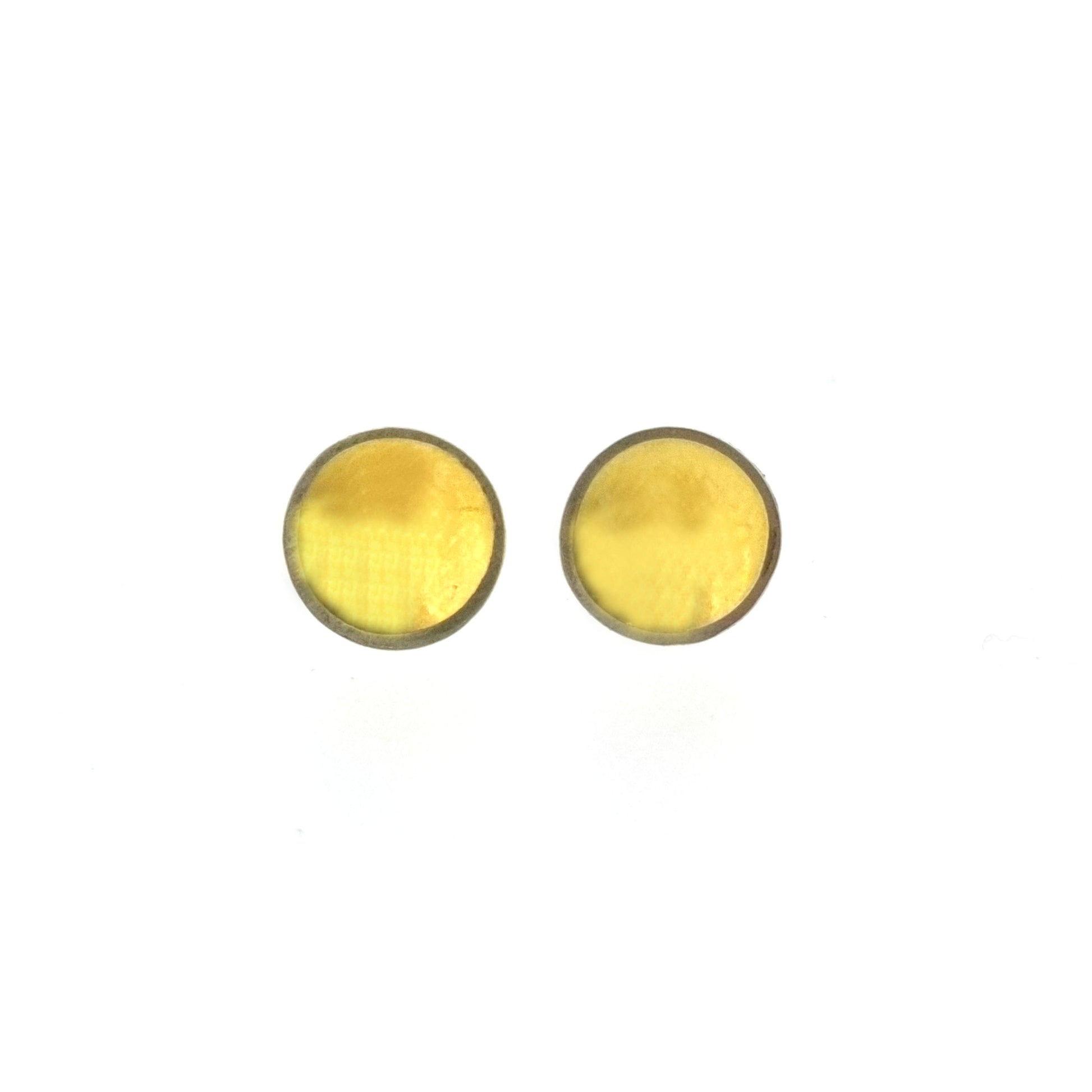 Silver round stud earrings with a gold center. Small.