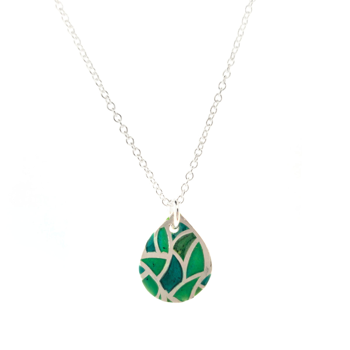 A handmade teardrop-shaped pendant necklace featuring a green enamel mosaic pattern with a silver chain, shown against a plain white background. Mijoux Jewellery.