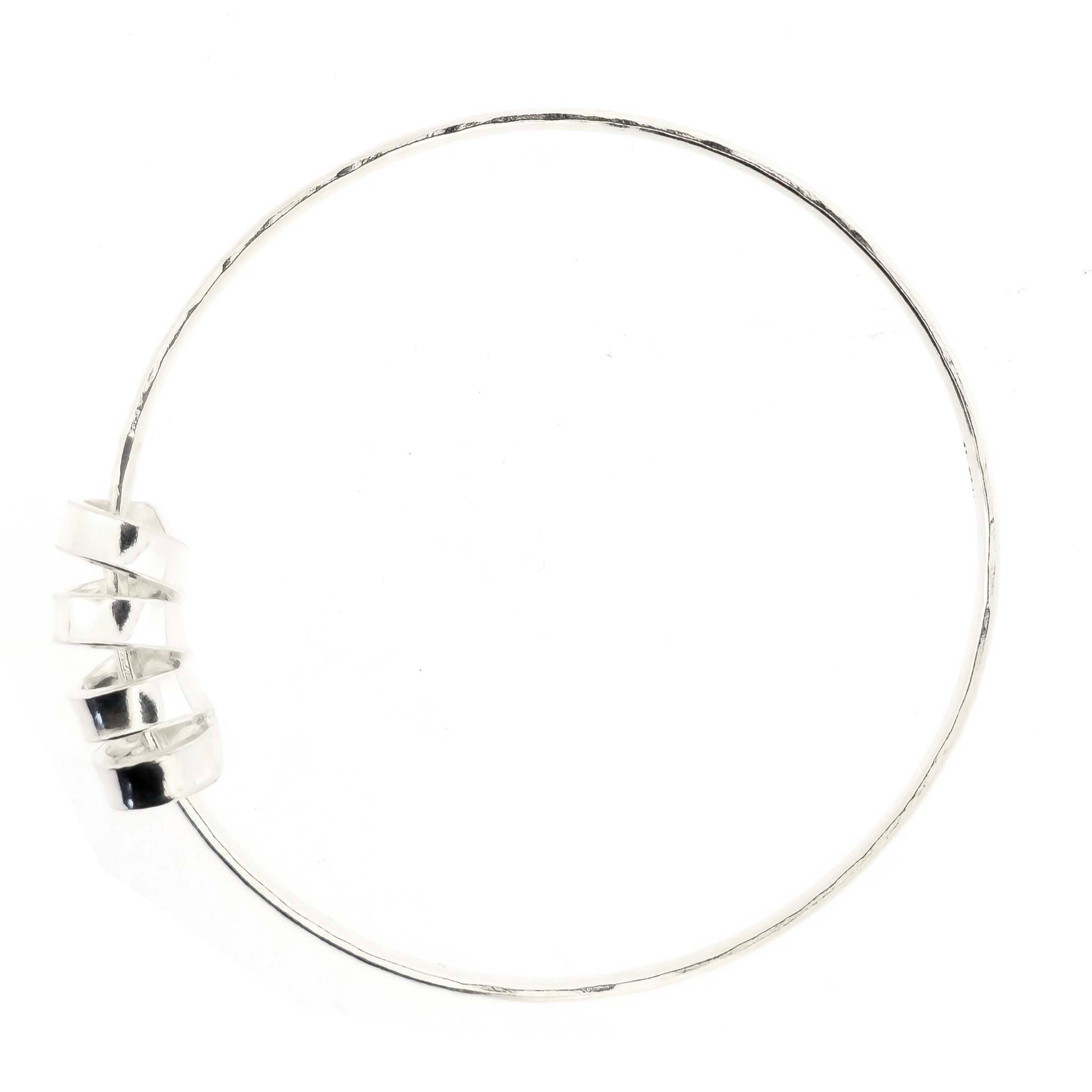 Silver bangle with a hammered finish and a wide spiral bead on a white background.