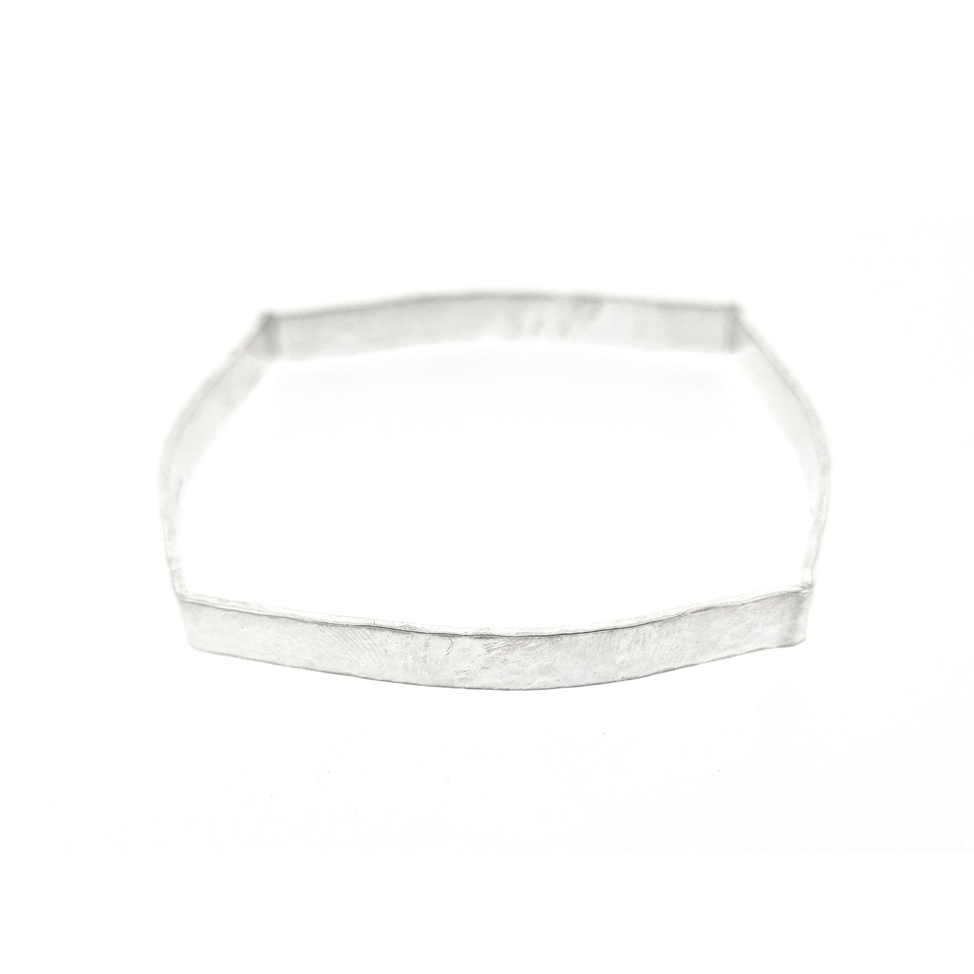Silver hammered bangle with a round and square profile.