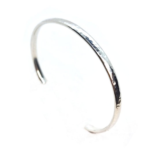 Silver hammered open torque bangle.