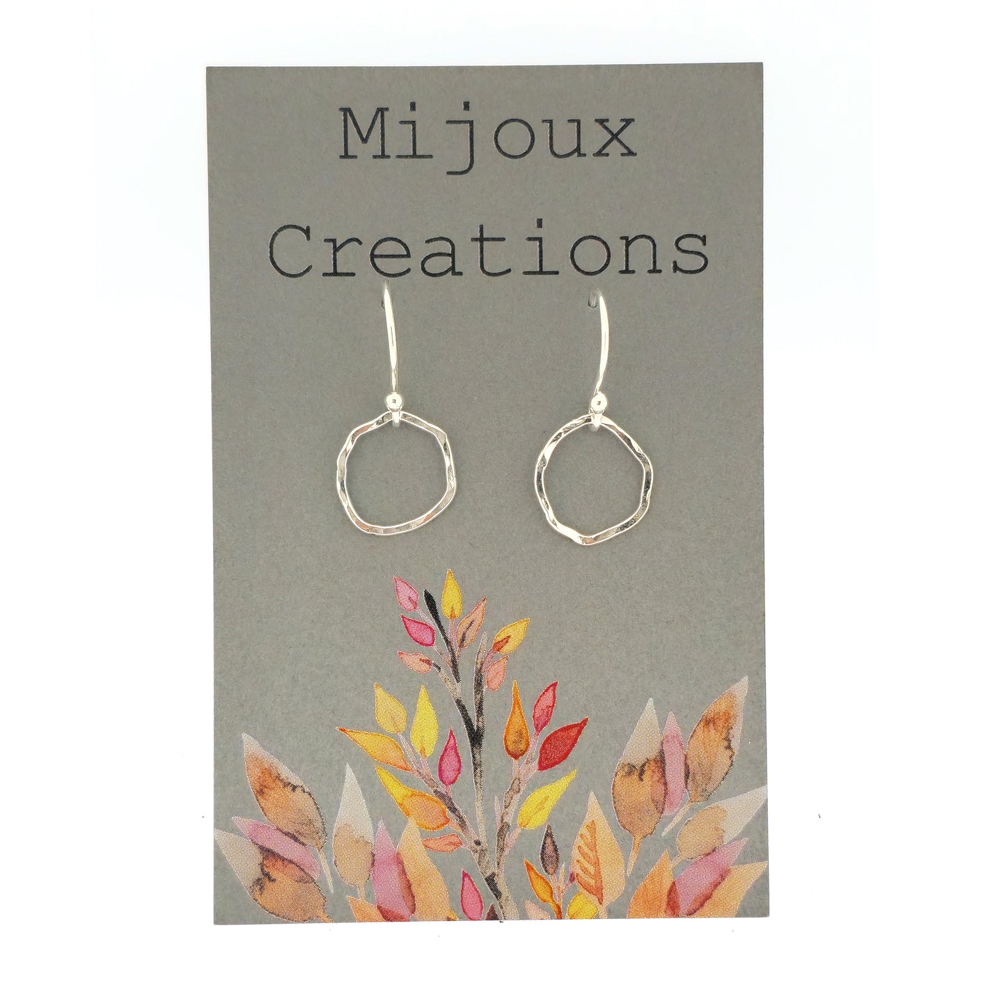 Silver drop earrings with an open organic rustic style circle suspended from silver ear wires - small. Shown on a Mijoux card.