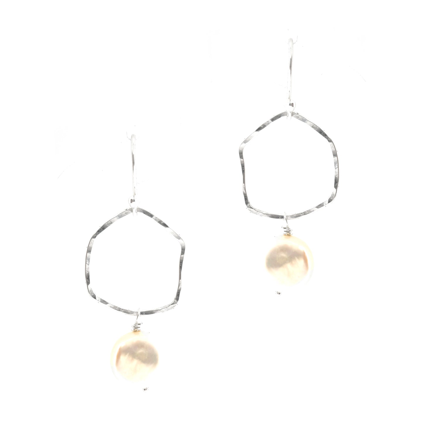 Silver drop earrings consisting of an organic rustic style open circle with a hammered finish suspended from silver ear hooks and with a white pearl hanging from it. Large.