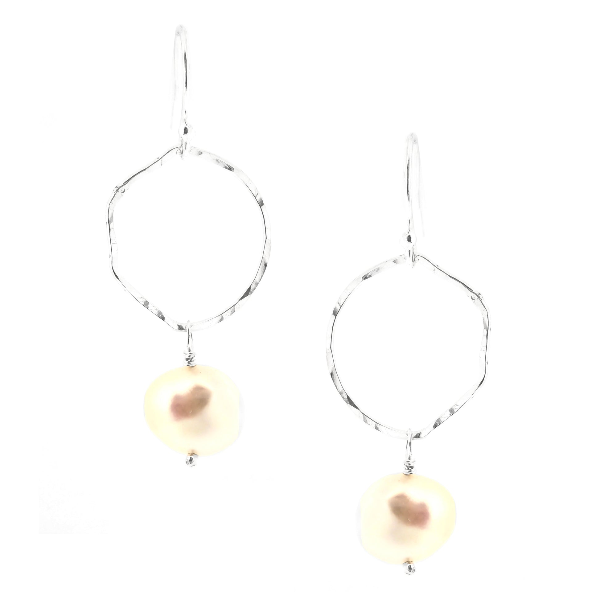 Silver drop earrings consisting of an organic rustic style open circle with a hammered finish suspended from silver ear hooks and with a white pearl hanging from it. Large.