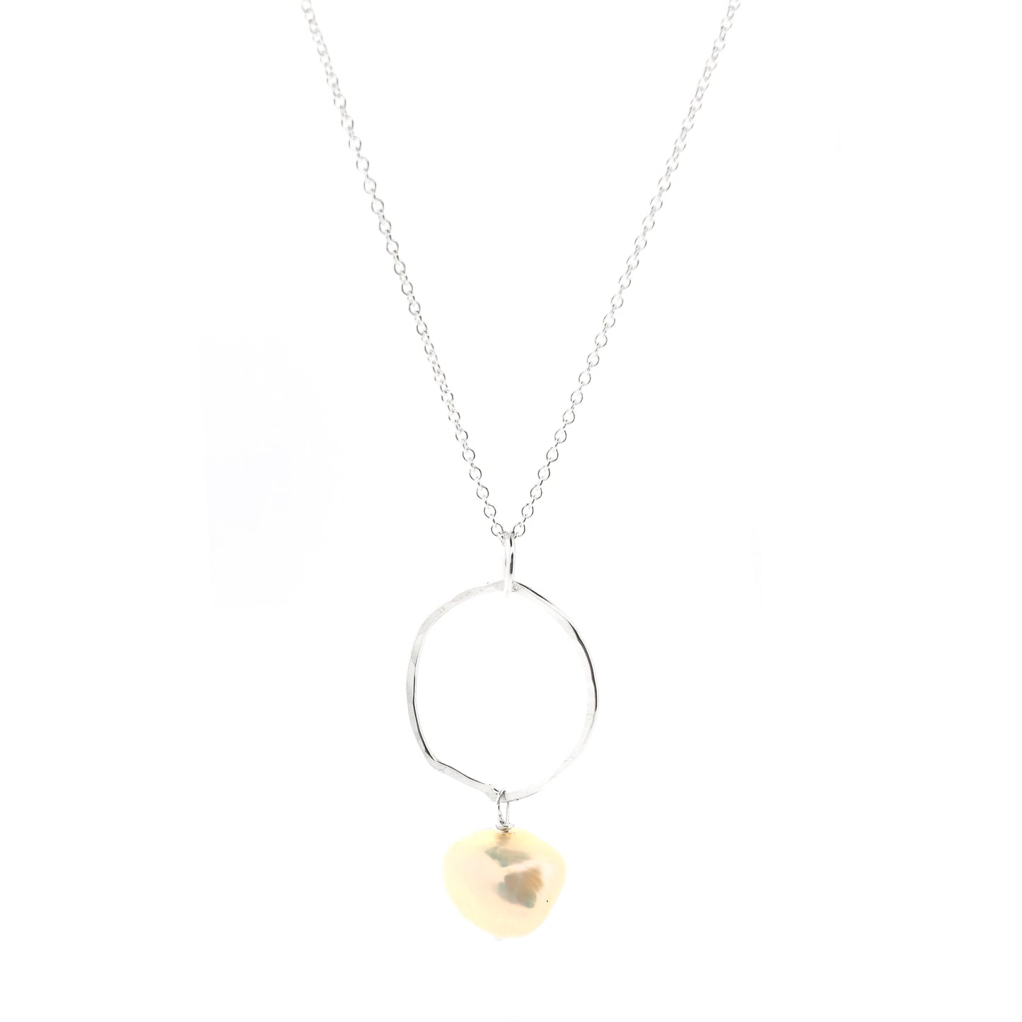 A silver pendant consisting of an organic rustic style open circle with a hammered finish and a pearl suspended from it. Hanging from a silver chain. Large.