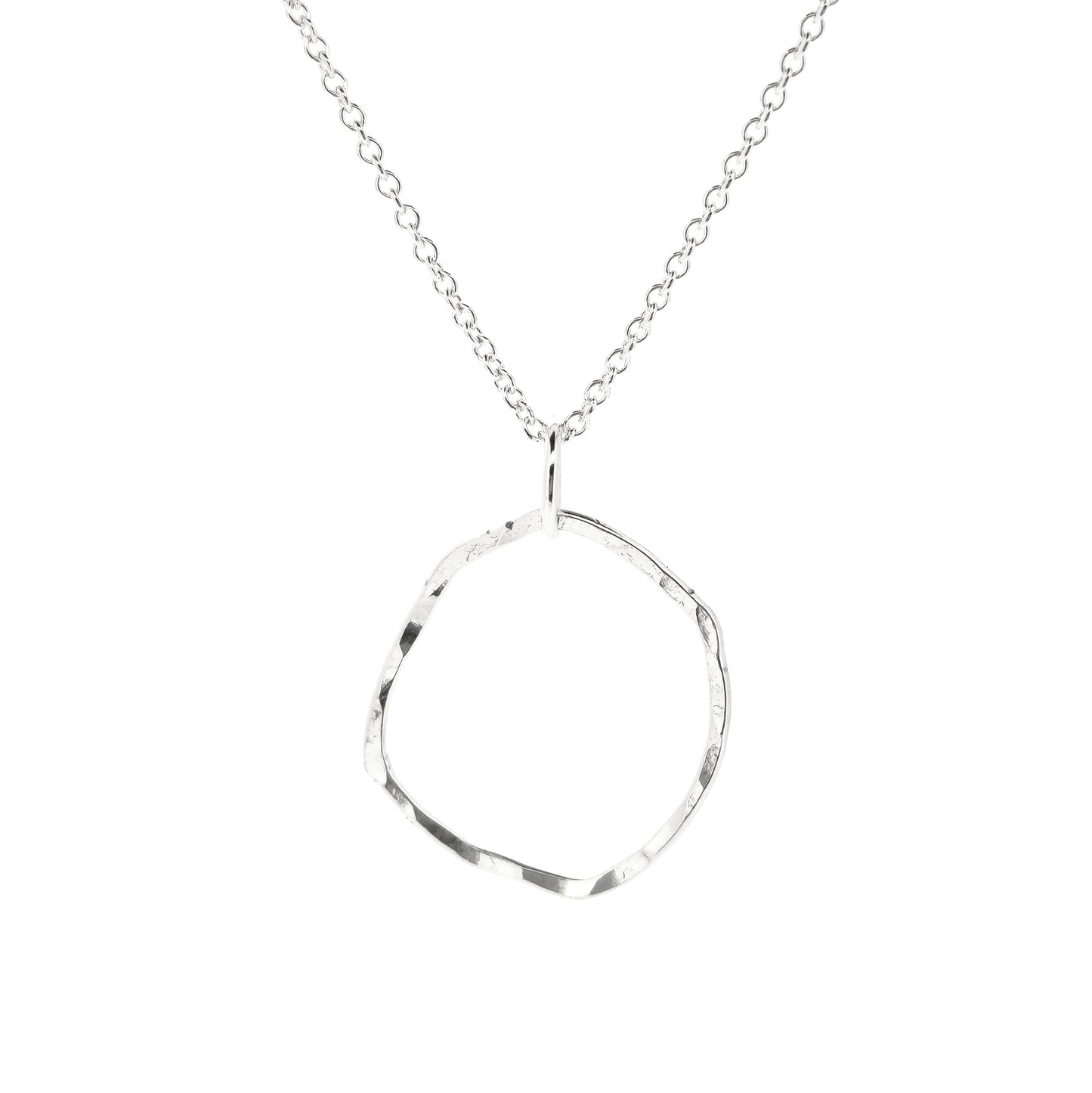 A silver pendant necklace consisting of an open organic rustic style silver circle with a hammered finish suspended from a silver chain - large.