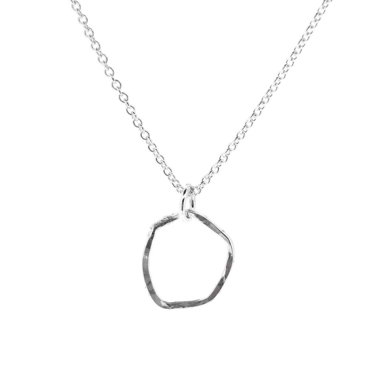 A silver pendant necklace consisting of an open organic rustic style silver circle with a hammered finish suspended from a silver chain - small.