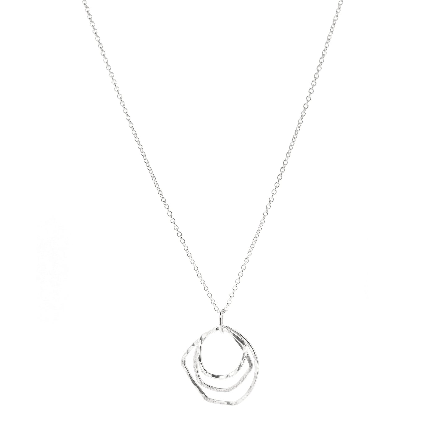 A silver pendant consisting of three organic rustic style circles of different sizes suspended together from a silver chain.