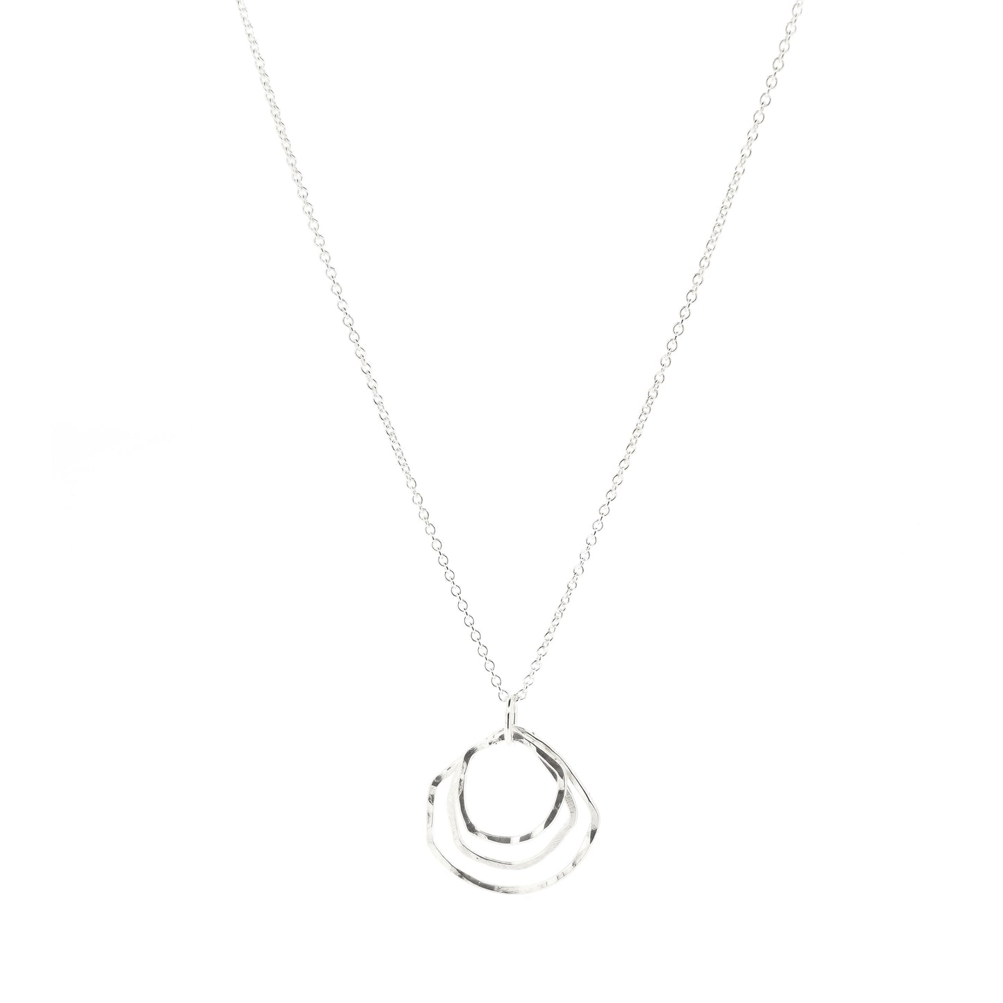 A silver pendant consisting of three organic rustic style circles of different sizes suspended together from a silver chain.