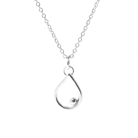 A silver open teardrop shaped pendant with an off-centre ball. On a silver chain. Small.