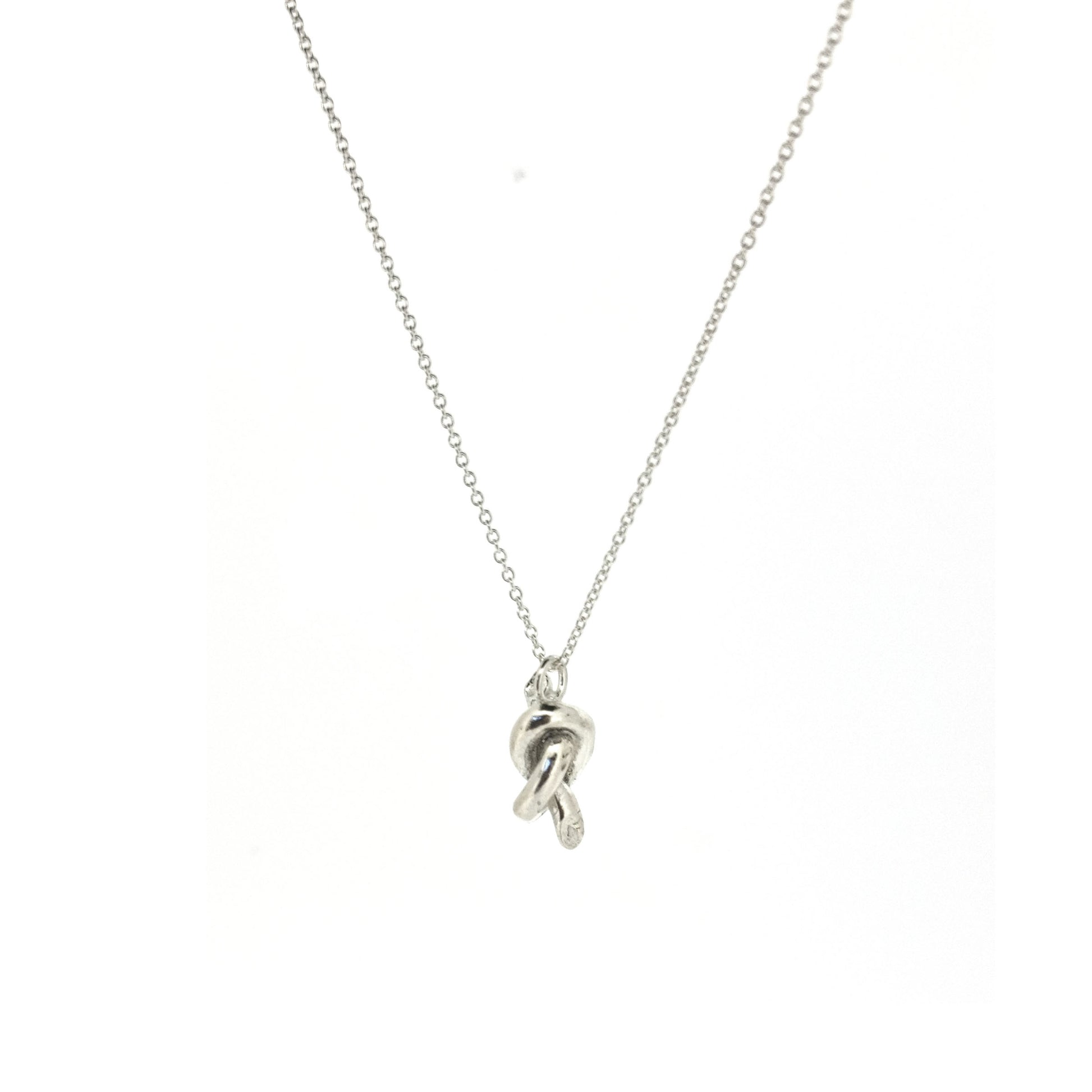 Silver chain with a silver knot pendant.