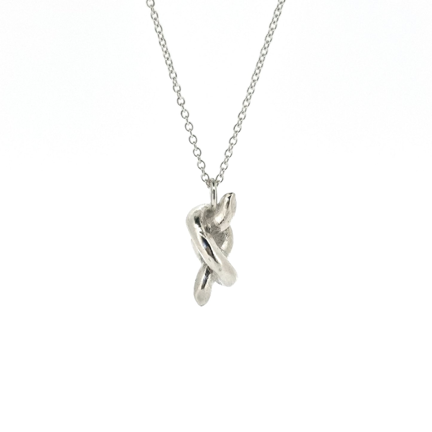 Silver chain with a silver knot pendant.