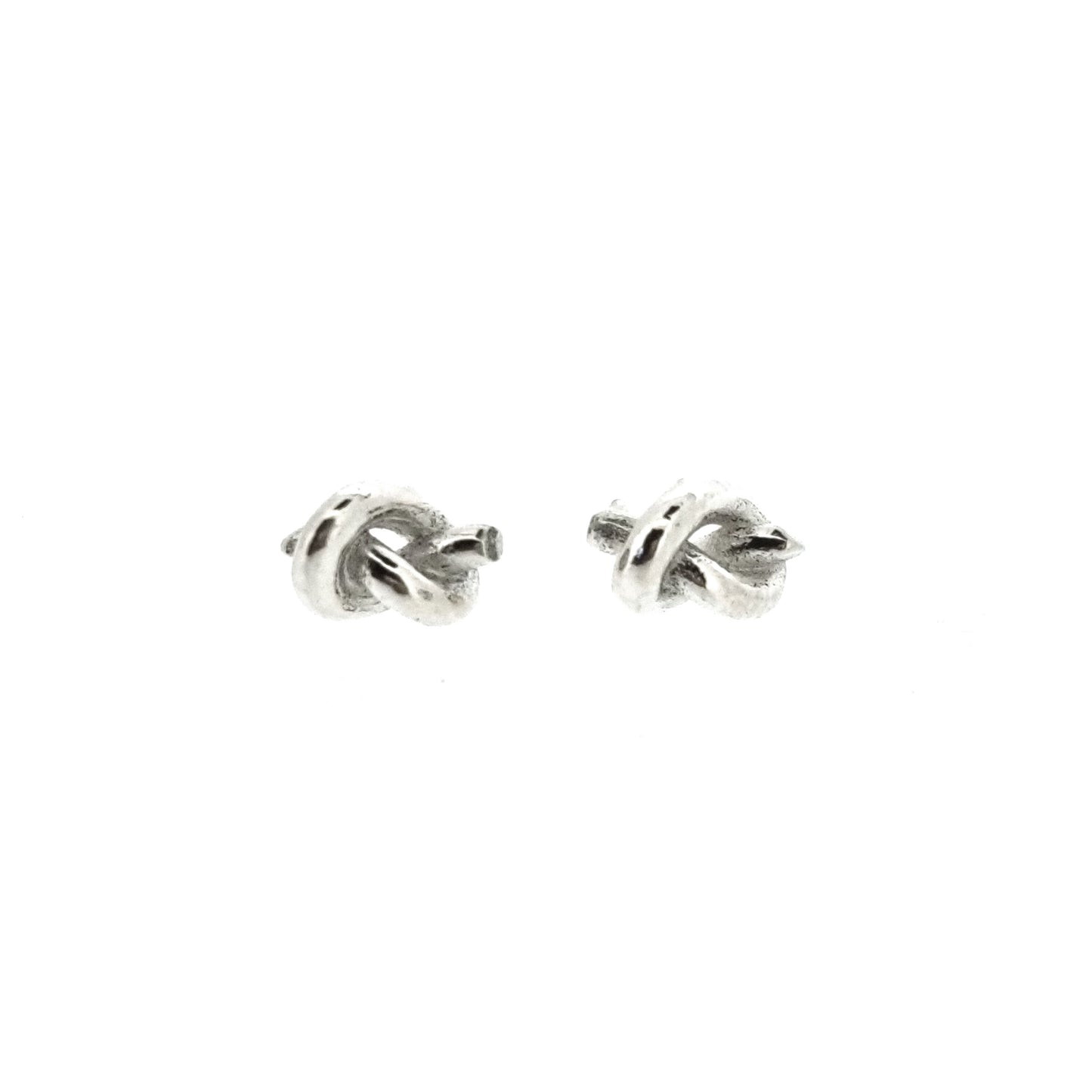 Silver stud earrings in the shape of a knot in a piece of string.