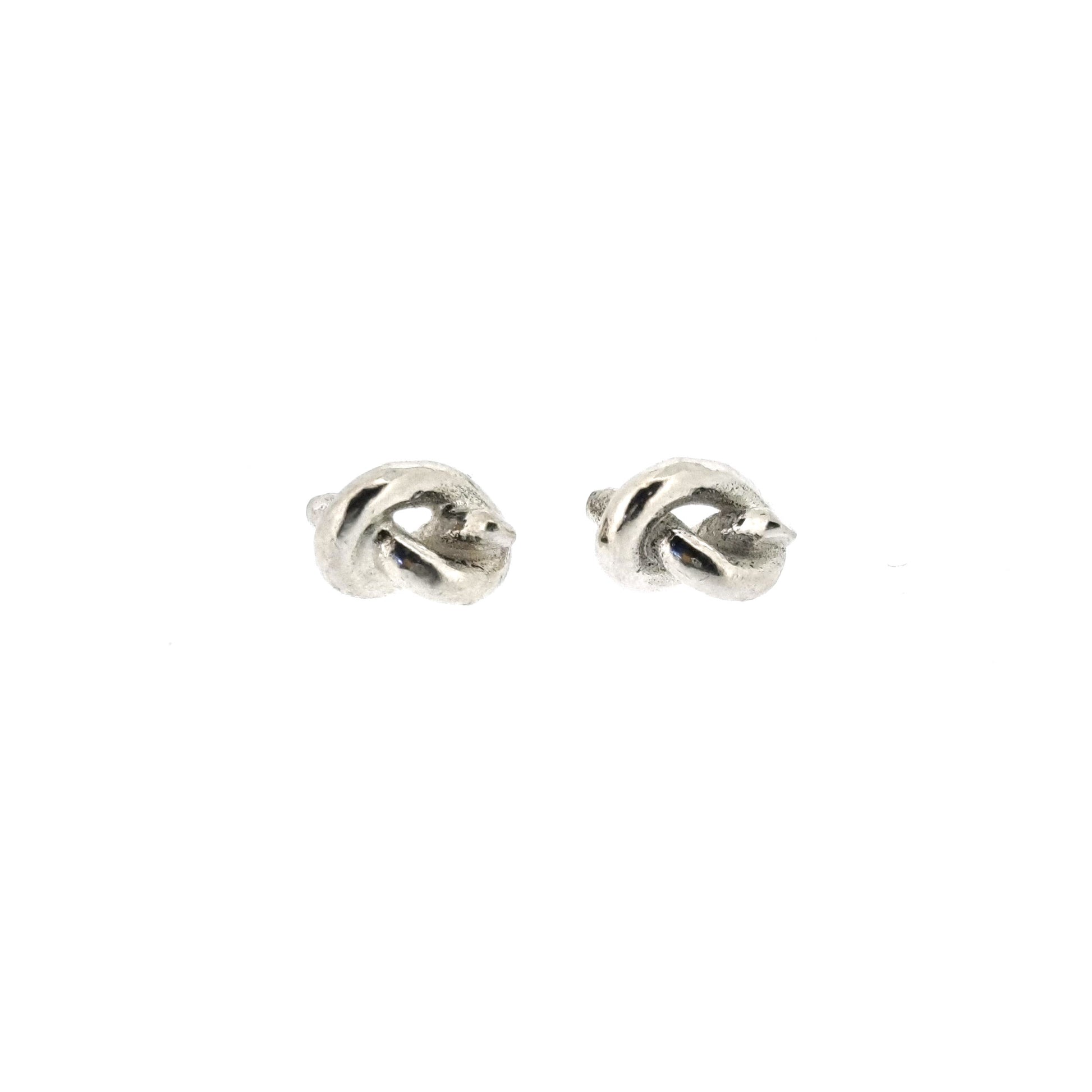 Silver stud earrings in the shape of a knot in a piece of string.