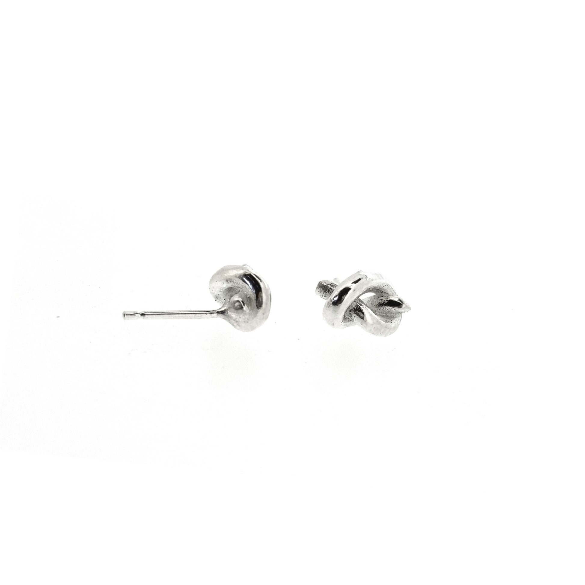 Silver stud earrings in the shape of a knot in a piece of string.