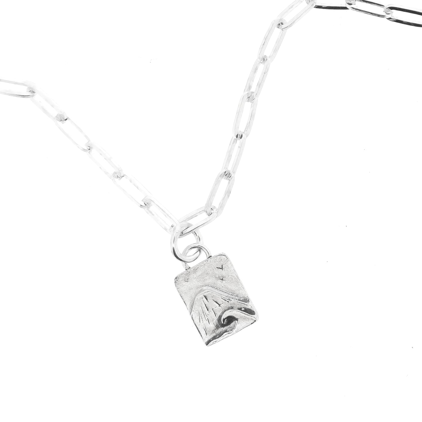 An silver bracelet with oblong links and a rectangular charm featuring a mountain and wave scene.