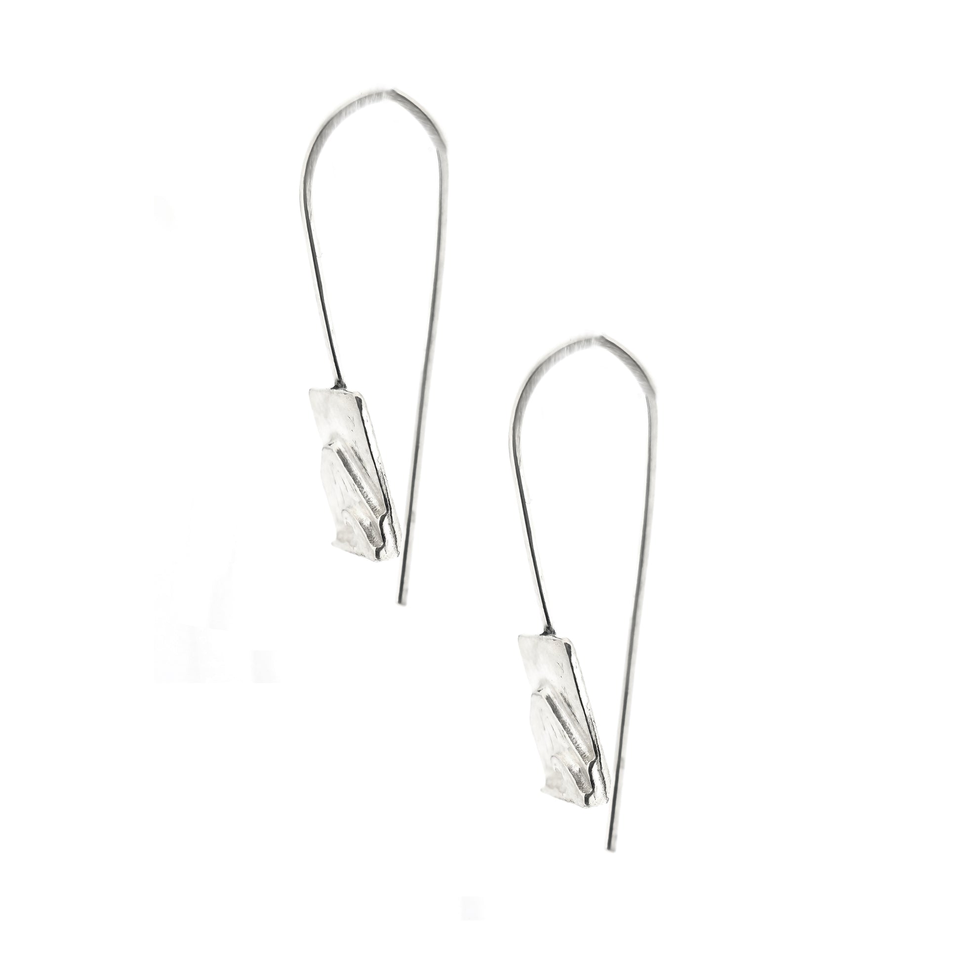 A pair of silver drop earrings featuring a rectangular section featuring a mountain and sea scene with birds on an ear wire. Side view.