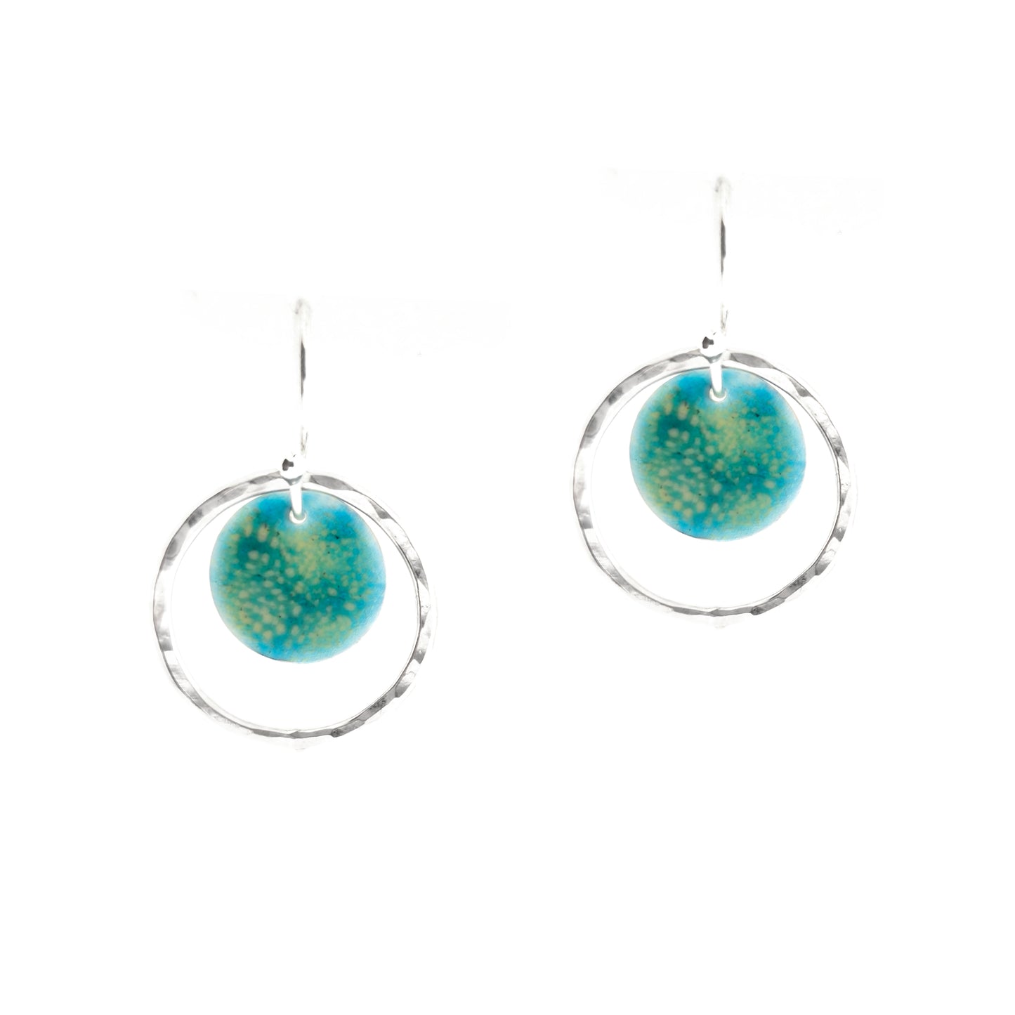 Silver drop earrings with a central silver disc covered with a turquoise enamel pattern and a surrounding hammered silver circle.