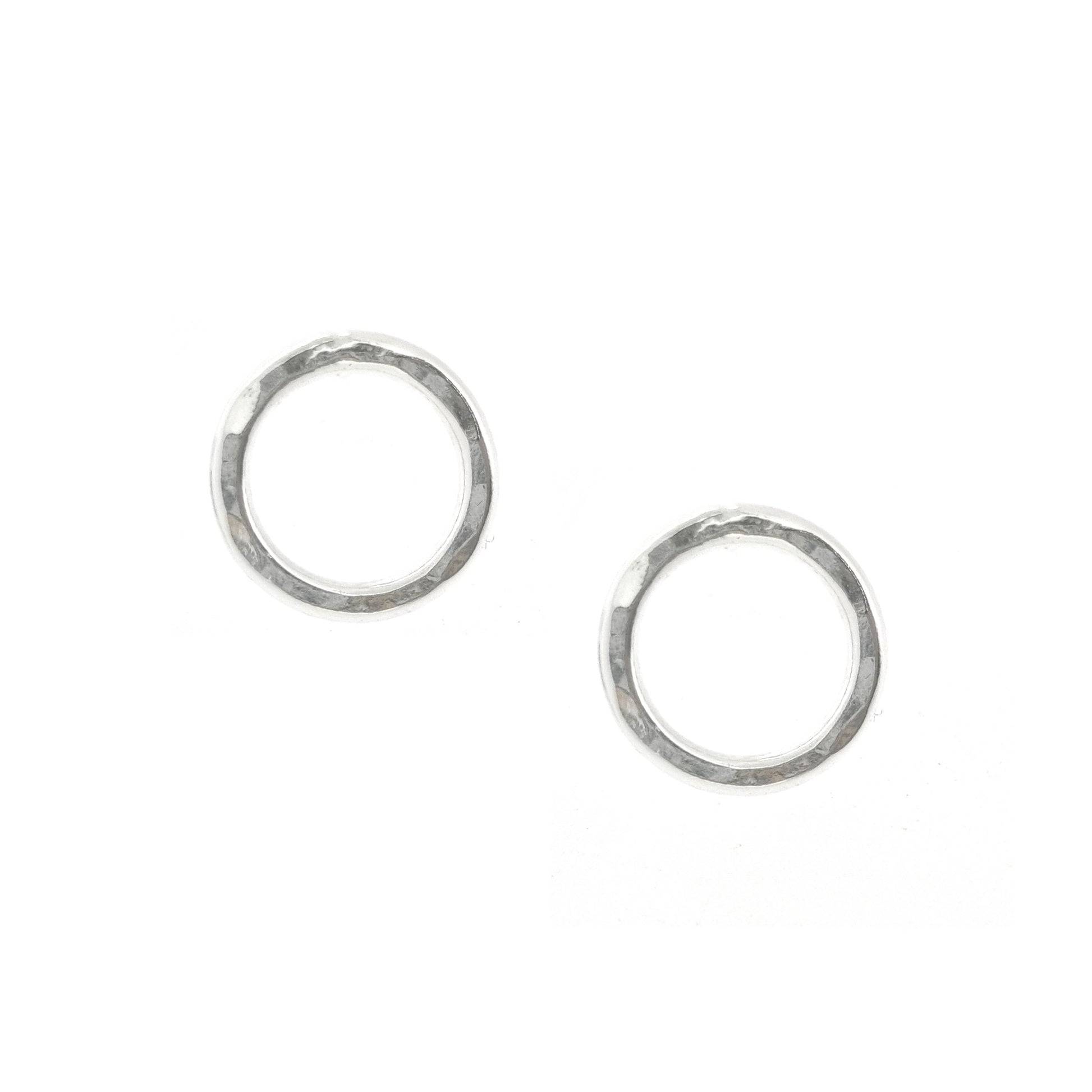 Silver open circle stud earrings with hammered texture.