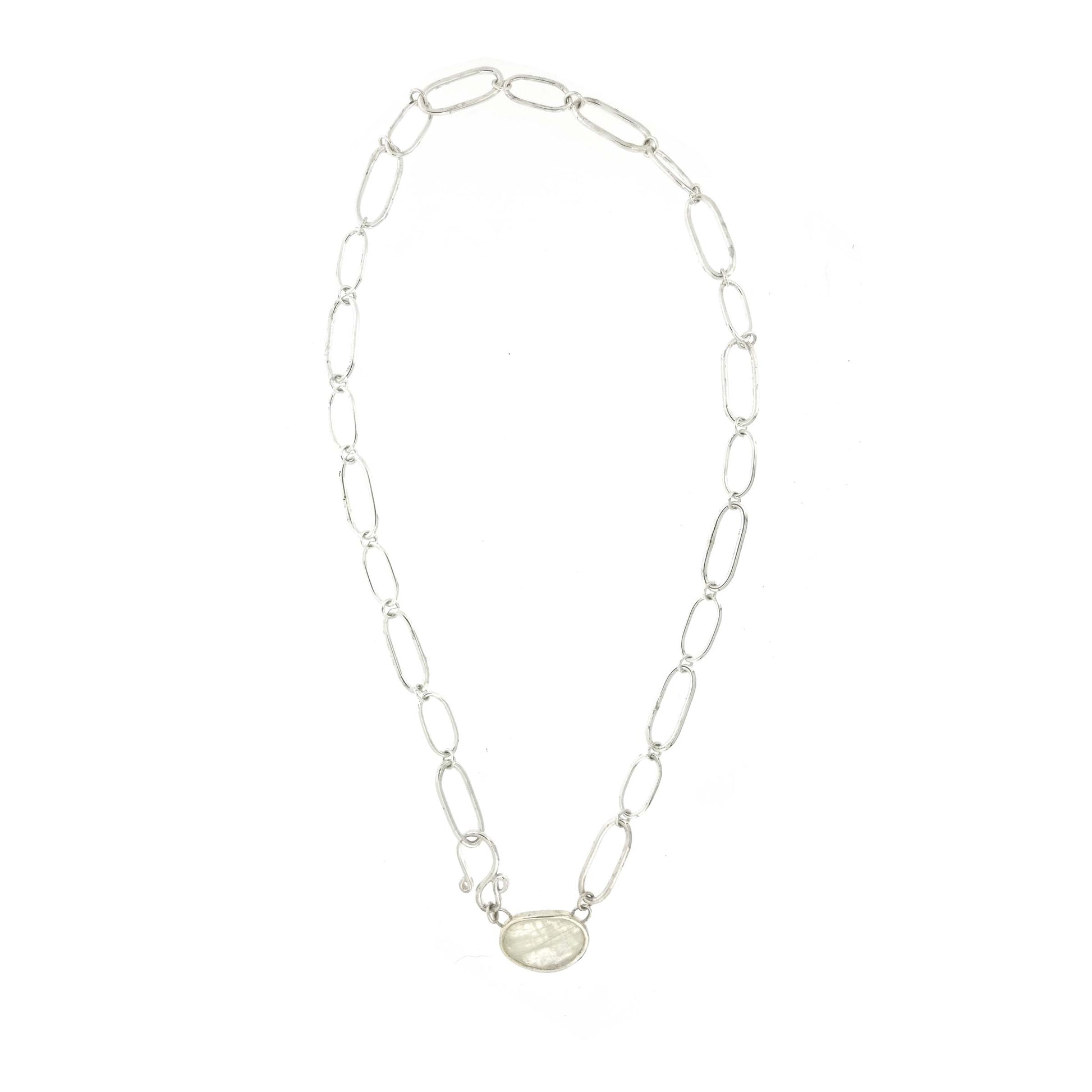 A silver chain necklace with open oblong links of different sizes, an s-clasp and a moonstone slice in a bezel setting.