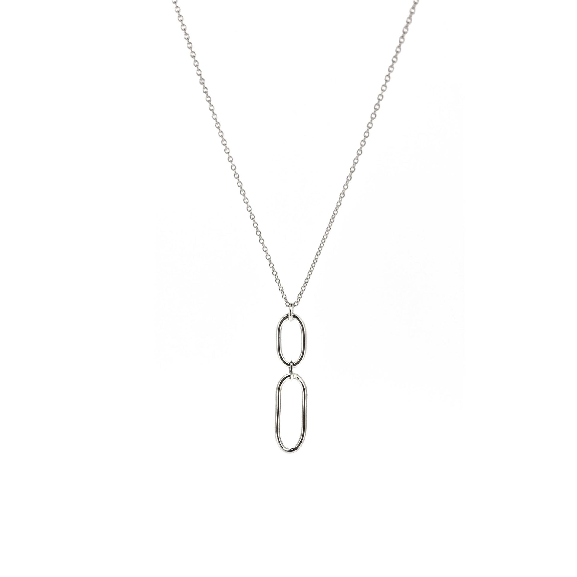 A silver pendant featuring 2 open oblong shapes on a silver chain.