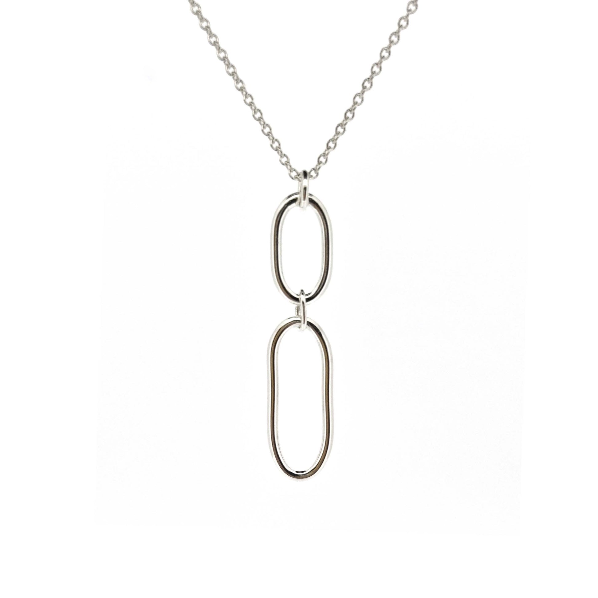 A silver pendant featuring 2 open oblong shapes on a silver chain.