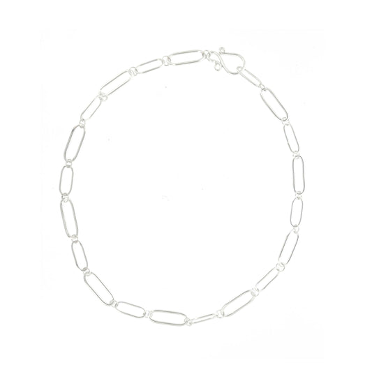 A silver chain necklace with open oblong links of different sizes and an s-clasp.