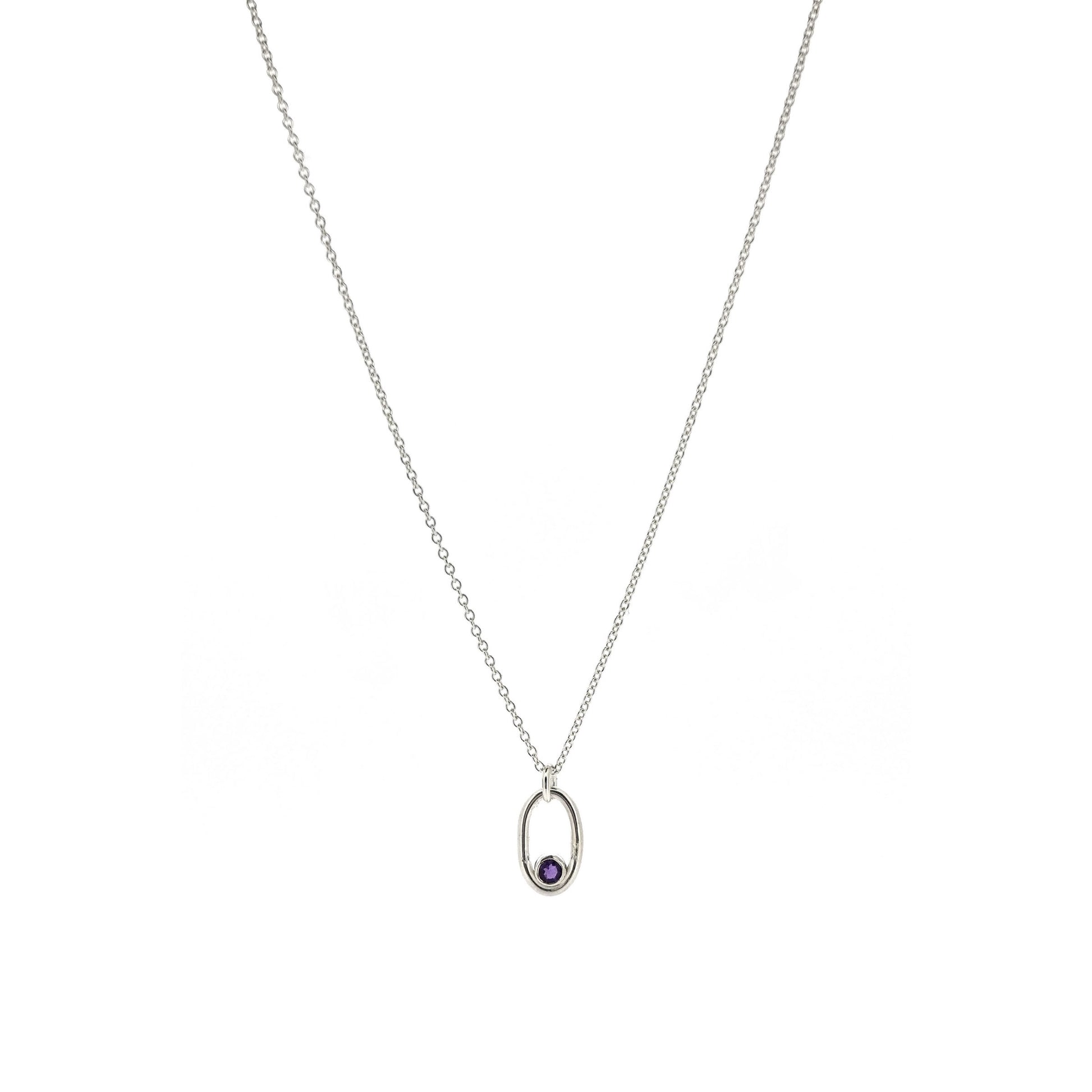 A silver open oblong pendant with a purple amethyst gemstone set in the curve, on a silver chain.